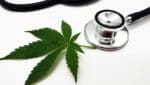 Closeup of a stethoscope with cannabis isolated on a white background