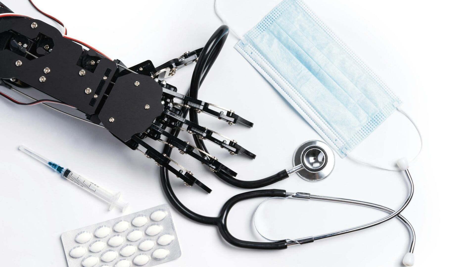 Real robotic hand with medical equipment and drugs.