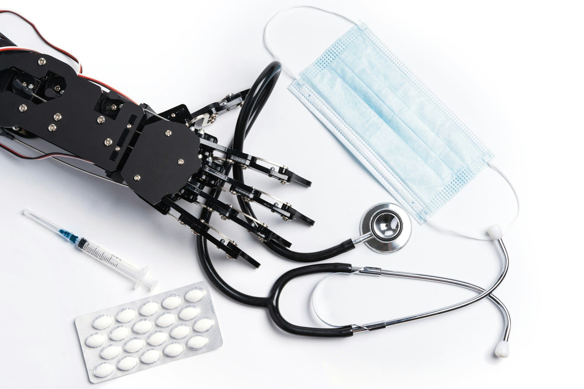 Real robotic hand with medical equipment and drugs.