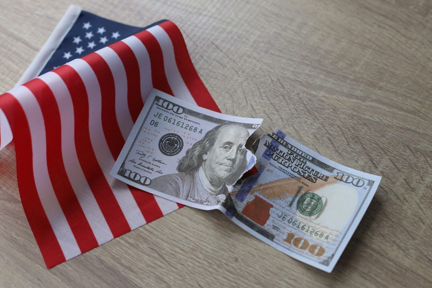 Torn dollar bill with American flag. Debt ceiling, stock market and financial concept.